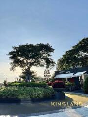 Outdoor view of a cafe with trees and landscaping