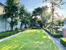 Spacious garden area with well-maintained lawn and trees