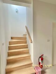 Indoor stairway with wooden steps and a handrail