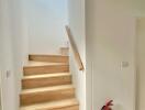 Indoor stairway with wooden steps and a handrail