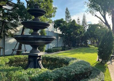 Beautifully landscaped garden with a black fountain centerpiece