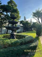 Beautifully landscaped garden with a black fountain centerpiece