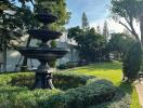 Beautifully landscaped garden with a black fountain centerpiece