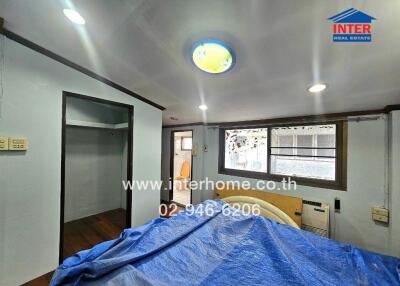 Bedroom with blue bedcover and window