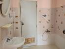 Bathroom with sink, door, and wall decorations