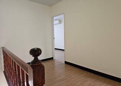 view of hallway with wooden railing