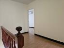 view of hallway with wooden railing