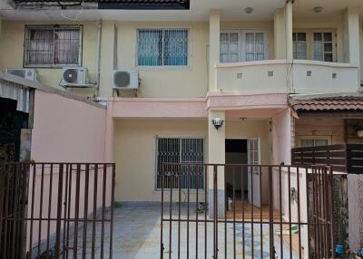 Front view of a residential property with driveway and gated entrance