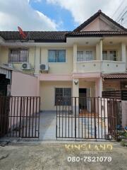 Front view of a residential property with driveway and gated entrance