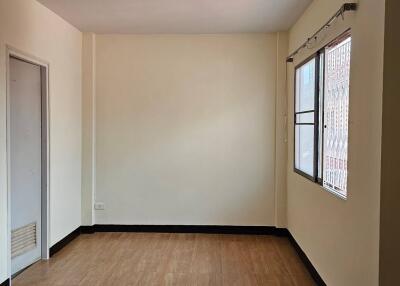 Empty bedroom with tiled floor and window