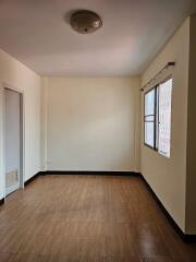 Empty bedroom with tiled floor and window