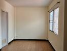 Empty bedroom with tiled floor and window