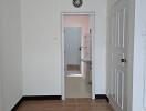 A view showing a doorway leading to a bathroom with a light neutral color scheme