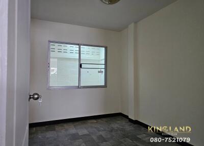 Small empty bedroom with tiled floor and window