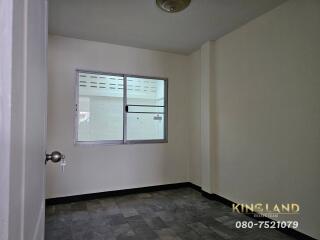 Small empty bedroom with tiled floor and window