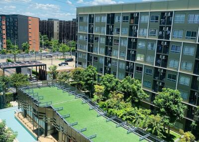 Exterior view of apartment buildings with greenery and open sky