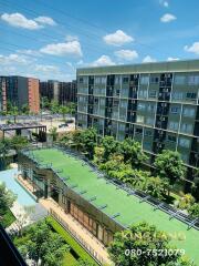 Exterior view of apartment buildings with greenery and open sky