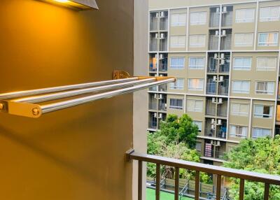 Balcony with view of apartment complex and green courtyard