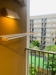 Balcony with view of apartment complex and green courtyard