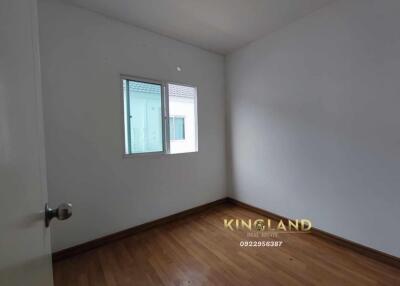 Empty bedroom with wooden floor and window