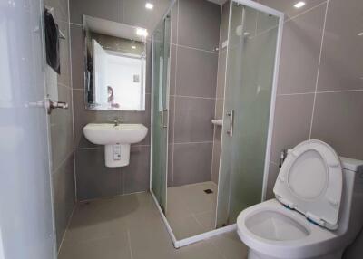 Modern bathroom with shower, sink, and toilet