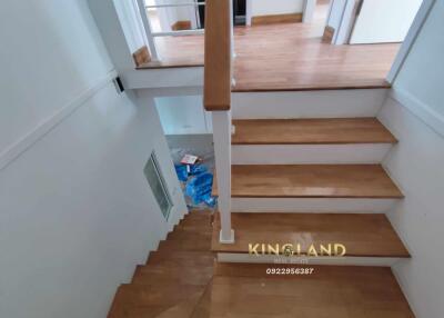 Staircase with wooden steps leading to upper floor