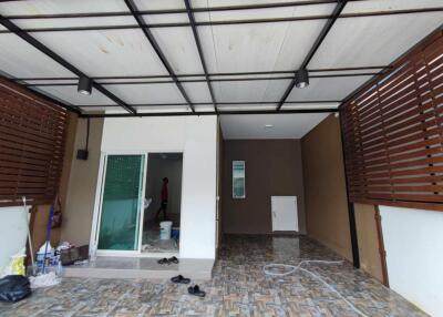 Covered outdoor area with tiled flooring and modern wooden paneling