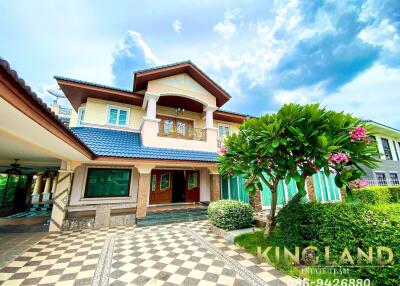 Front view of a two-story house with a garden