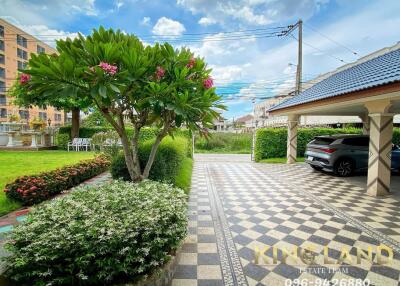 Beautiful garden area with parked cars and well-maintained greenery