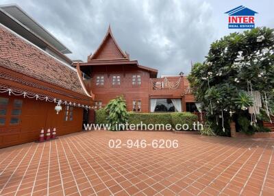 Traditional style house with terracotta roofing and greenery