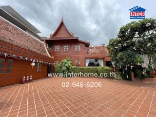 Traditional style house with terracotta roofing and greenery