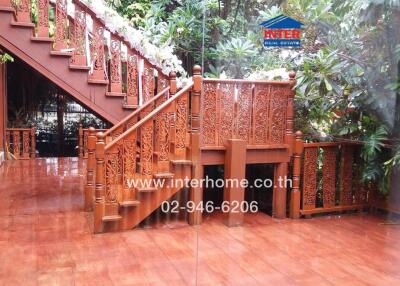 Outdoor wooden stairway surrounded by greenery