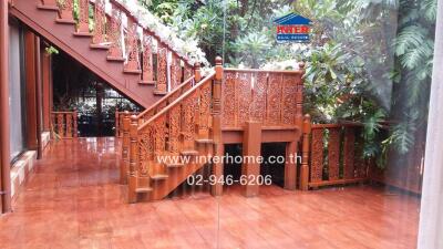 Outdoor wooden stairway surrounded by greenery