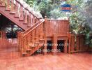 Outdoor wooden stairway surrounded by greenery