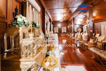 Spacious living room with traditional wooden interior and antique-style furniture