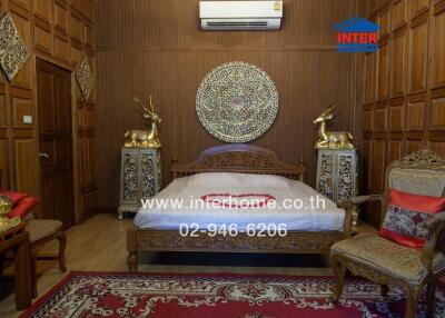 Ornately decorated bedroom with wooden wall paneling