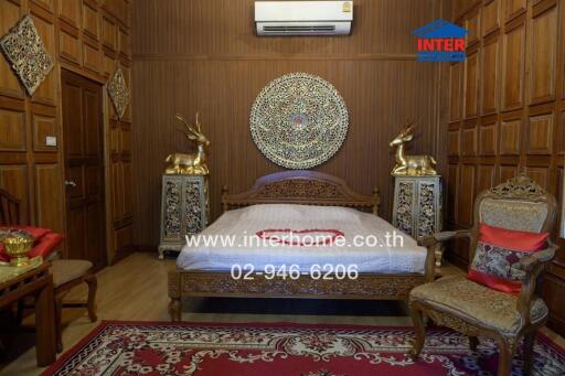 Ornately decorated bedroom with wooden wall paneling