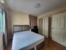 Spacious bedroom with double bed and large wardrobe