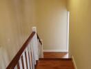 Indoor staircase with wooden steps and railing