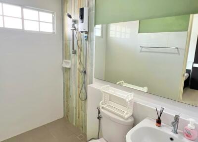 Modern bathroom with shower, toilet, and sink