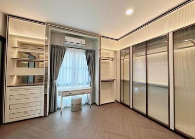 Spacious bedroom with built-in wardrobe and vanity area