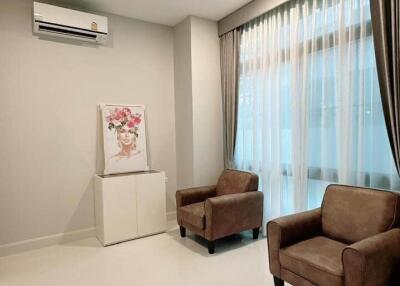 Living room with brown chairs and air conditioner