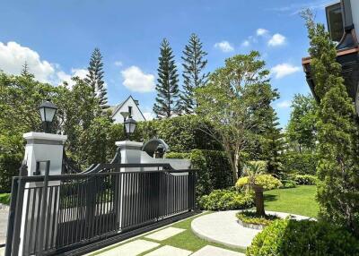 Front yard with well-maintained garden and gated entrance