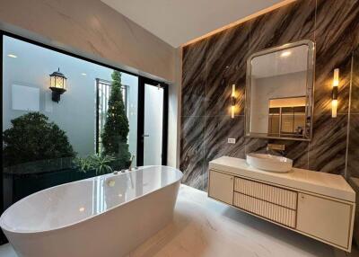 Modern bathroom with bathtub and stylish lighting