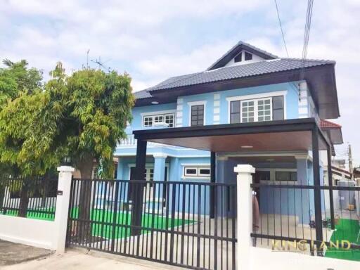 Front view of a two-story house with a blue and white facade