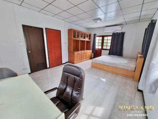 Spacious bedroom with desk and built-in shelving