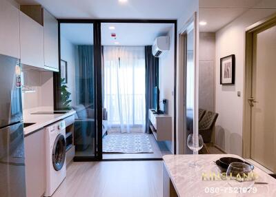 Modern living area with kitchenette and washing machine