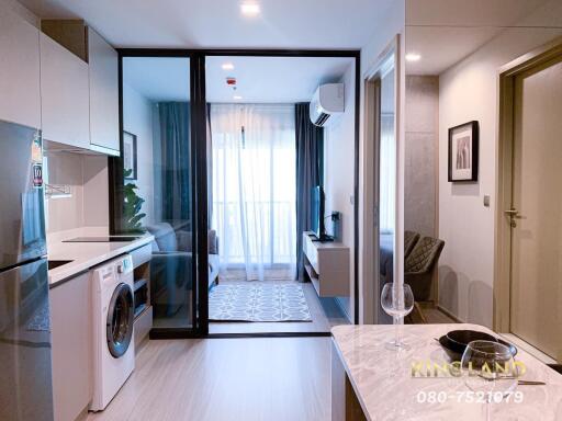 Modern living area with kitchenette and washing machine