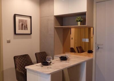 Modern dining area with two chairs and a built-in storage cabinet