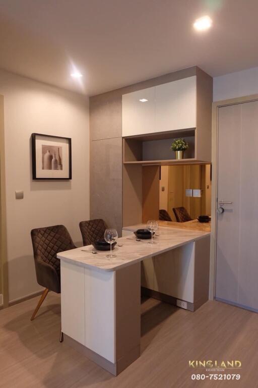 Modern dining area with two chairs and a built-in storage cabinet